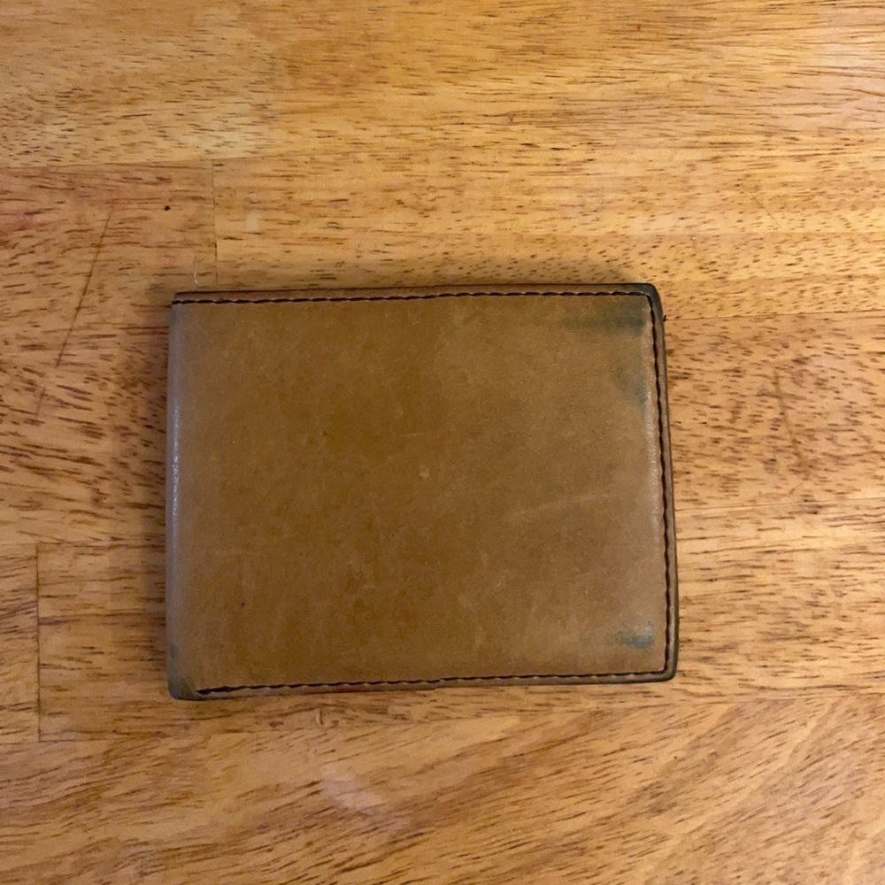 Fossil bifold wallet with "Fossil Fuel" branding. Elegant Tan Leather